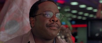 Movie still from “Johnson Family Vacation” (2004), directed by Christopher Erskin – A person wearing glasses; Close Up shot, Over the shoulder angle