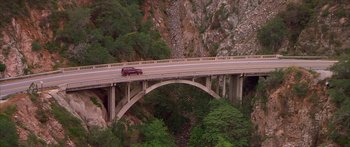 Movie still from “Johnson Family Vacation” (2004), directed by Christopher Erskin – A car is driving on a bridge over a river; Extreme Wide shot, High angle