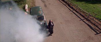 Movie still from “Johnson Family Vacation” (2004), directed by Christopher Erskin – A nun standing in front of an antique car; Wide shot, Overhead angle