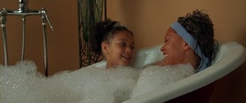 Movie still from “Johnson Family Vacation” (2004), directed by Christopher Erskin – A woman and a girl in a bubble bath; Medium shot, High angle