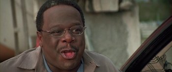 Movie still from “Johnson Family Vacation” (2004), directed by Christopher Erskin – A person wearing glasses and a jacket; Close Up shot, Low angle