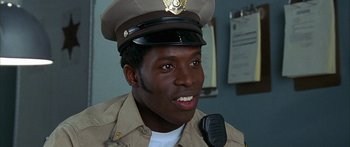 Movie still from “Johnson Family Vacation” (2004), directed by Christopher Erskin – A man wearing a uniform and a hat; Close Up shot, Low angle