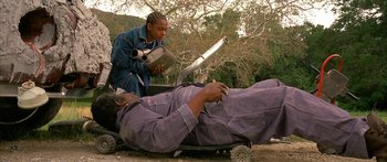 Movie still from “Johnson Family Vacation” (2004), directed by Christopher Erskin – A man laying on the ground next to another man; Medium shot, High angle