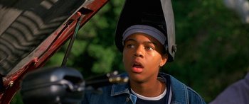 Movie still from “Johnson Family Vacation” (2004), directed by Christopher Erskin – A young man with a helmet on his head looking surprised; Close Up shot, High angle