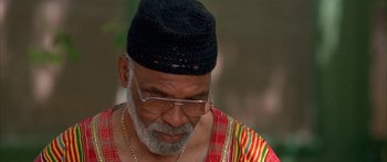 Movie still from “Johnson Family Vacation” (2004), directed by Christopher Erskin – An older man wearing a hat and glasses; Close Up shot, Low angle