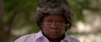Movie still from “Johnson Family Vacation” (2004), directed by Christopher Erskin – An older black woman wearing glasses and a gray wig; Close Up shot, Low angle