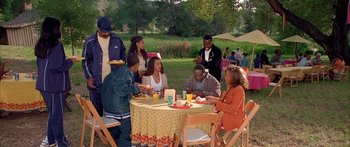 Movie still from “Johnson Family Vacation” (2004), directed by Christopher Erskin – A group of people sitting around a table eating; Wide shot, High angle