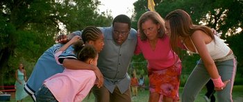 Movie still from “Johnson Family Vacation” (2004), directed by Christopher Erskin – A group of people standing next to each other in a field; Medium shot, High angle