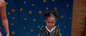 Movie still from “Johnson Family Vacation” (2004), directed by Christopher Erskin – A little girl standing in front of a wall of sunflowers; Close Up shot, High angle