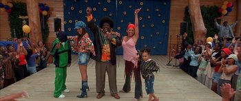 Movie still from “Johnson Family Vacation” (2004), directed by Christopher Erskin – A group of people standing next to each other on a stage; Wide shot, Low angle