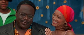 Movie still from “Johnson Family Vacation” (2004), directed by Christopher Erskin – A man and a woman smiling for the camera; Close Up shot, Low angle
