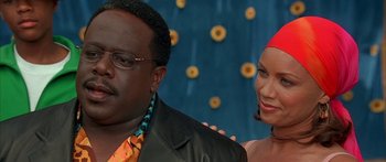 Movie still from “Johnson Family Vacation” (2004), directed by Christopher Erskin – A man and a woman standing next to each other in front of sunflowers; Close Up shot, Over the shoulder angle