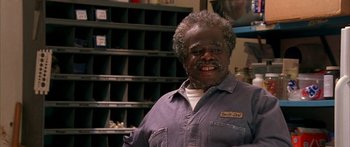 Movie still from “Johnson Family Vacation” (2004), directed by Christopher Erskin – An older man with grey hair smiling for the camera; Close Up shot, High angle