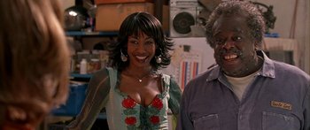 Movie still from “Johnson Family Vacation” (2004), directed by Christopher Erskin – A woman and a man standing next to each other in a room; Medium shot, Low angle