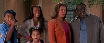 Movie still from “Johnson Family Vacation” (2004), directed by Christopher Erskin – A group of people standing next to each other on a porch; Medium shot, High angle