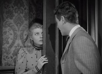 Movie still from “Kings Row” (1942), directed by Sam Wood – A man and a woman are looking at each other; Medium shot, High angle