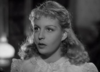 Movie still from “Kings Row” (1942), directed by Sam Wood – A black - and - white photo of a young woman; Close Up shot, Over the shoulder angle