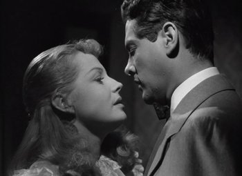 Movie still from “Kings Row” (1942), directed by Sam Wood – A man and a woman face to face in a black and white photo; Close Up shot, Low angle