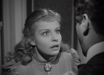 Movie still from “Kings Row” (1942), directed by Sam Wood – A young woman looking at the camera in a black and white photo; Close Up shot, Over the shoulder angle