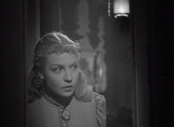 Movie still from “Kings Row” (1942), directed by Sam Wood – A black - and - white photo of a woman looking at the camera; Close Up shot, High angle