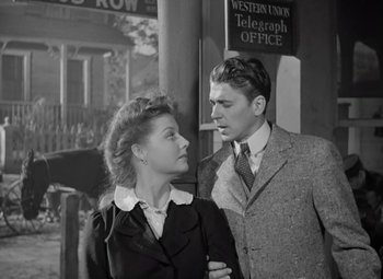 Movie still from “Kings Row” (1942), directed by Sam Wood – A man and a woman standing next to each other; Medium shot, Low angle
