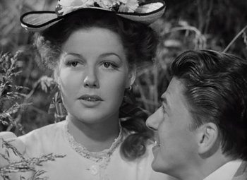 Movie still from “Kings Row” (1942), directed by Sam Wood – An old photo of a man and a woman; Close Up shot, Over the shoulder angle