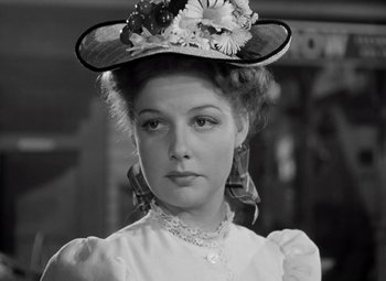 Movie still from “Kings Row” (1942), directed by Sam Wood – A young woman wearing a hat with flowers on it; Close Up shot, Low angle
