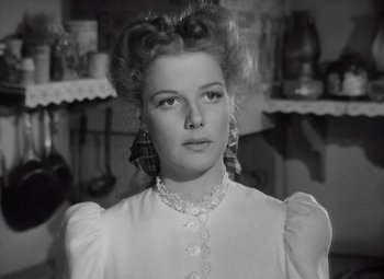 Movie still from “Kings Row” (1942), directed by Sam Wood – A black - and - white photo of a woman in a white dress; Close Up shot, Low angle