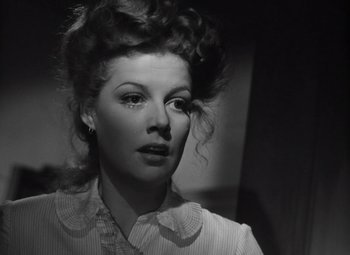 Movie still from “Kings Row” (1942), directed by Sam Wood – A black and white photo of a woman in a white shirt; Close Up shot, Low angle