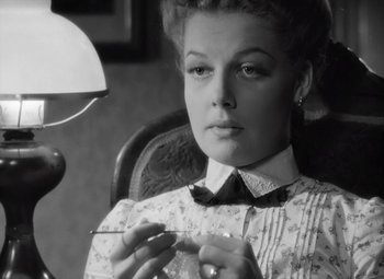 Movie still from “Kings Row” (1942), directed by Sam Wood – A black and white photo of a woman knitting; Close Up shot, Low angle