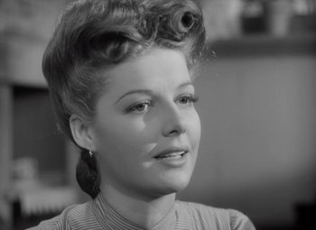 Movie still from “Kings Row” (1942), directed by Sam Wood – A black and white photo of a woman with a hairdo; Close Up shot, Low angle