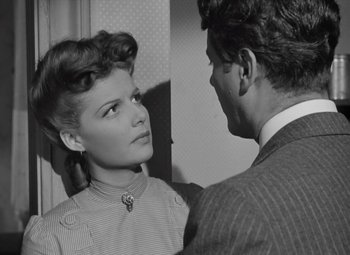 Movie still from “Kings Row” (1942), directed by Sam Wood – An old photo of a man and a woman; Close Up shot, Over the shoulder angle