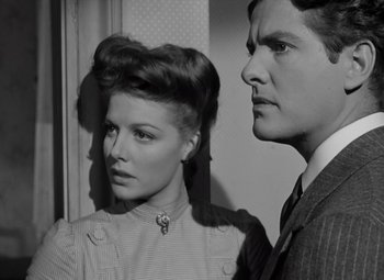 Movie still from “Kings Row” (1942), directed by Sam Wood – A man and a woman standing next to each other; Close Up shot, Low angle