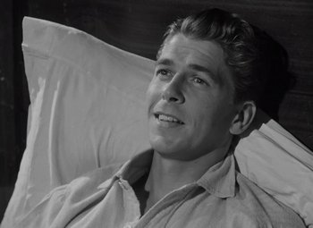 Movie still from “Kings Row” (1942), directed by Sam Wood – Black and white photograph of a young man in bed; Close Up shot, High angle
