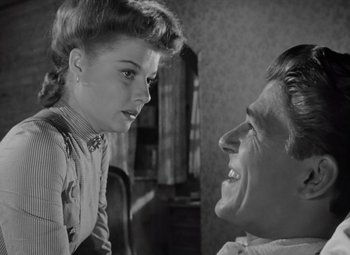 Movie still from “Kings Row” (1942), directed by Sam Wood – An old black and white photo of a man and a woman; Close Up shot, Over the shoulder angle