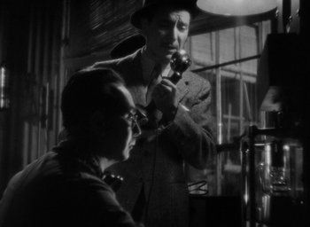 Movie still from “Lost Horizon” (1937), directed by Frank Capra – A man and a woman are smoking pipes in a dark room; Close Up shot, Low angle