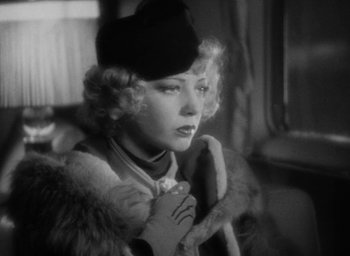 Movie still from “Lost Horizon” (1937), directed by Frank Capra – An old photo of a woman in a fur coat and a hat; Close Up shot, Over the shoulder angle