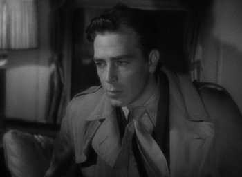 Movie still from “Lost Horizon” (1937), directed by Frank Capra – A black and white photo of a man in a trench coat; Close Up shot, Over the shoulder angle