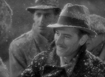 Movie still from “Lost Horizon” (1937), directed by Frank Capra – A man wearing a hat and a coat; Close Up shot, Over the shoulder angle