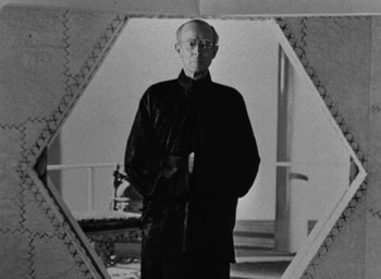 Movie still from “Lost Horizon” (1937), directed by Frank Capra – An older man standing in front of a mirror; Medium shot, Low angle