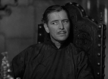 Movie still from “Lost Horizon” (1937), directed by Frank Capra – A man sitting in a chair looking up at the sky; Close Up shot, High angle