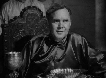Movie still from “Lost Horizon” (1937), directed by Frank Capra – A man sitting at a table with a plate of food; Close Up shot, High angle