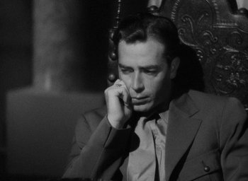 Movie still from “Lost Horizon” (1937), directed by Frank Capra – A black and white photo of a man on a cell phone; Close Up shot, Low angle