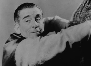 Movie still from “Lost Horizon” (1937), directed by Frank Capra – An old black and white photo of a man holding a baseball glove; Close Up shot, Low angle