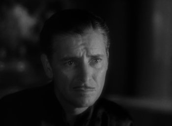 Movie still from “Lost Horizon” (1937), directed by Frank Capra – Black and white photograph of a man looking sad; Close Up shot, Low angle