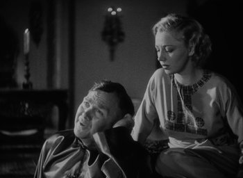 Movie still from “Lost Horizon” (1937), directed by Frank Capra – An older woman sitting on the shoulder of an older man; Medium shot, High angle