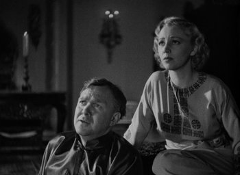 Movie still from “Lost Horizon” (1937), directed by Frank Capra – An older man sitting next to an older woman; Close Up shot, Low angle