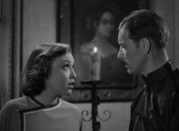 Movie still from “Lost Horizon” (1937), directed by Frank Capra – A man and a woman standing next to each other in a room; Close Up shot, Low angle