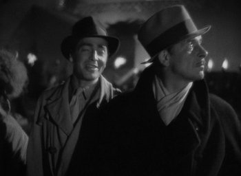 Movie still from “Lost Horizon” (1937), directed by Frank Capra – A couple of men standing next to each other wearing hats; Close Up shot, Low angle