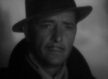 Movie still from “Lost Horizon” (1937), directed by Frank Capra – An older man wearing a hat and a jacket; Close Up shot, Low angle